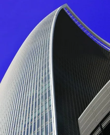 A modern high-rise building with a unique curved structure